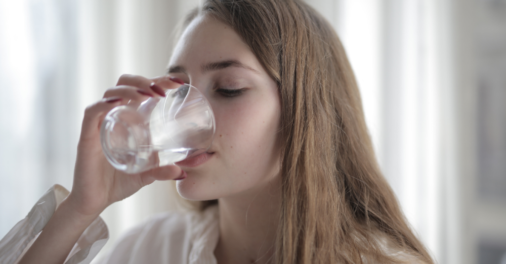 photo of a girl drinking water 