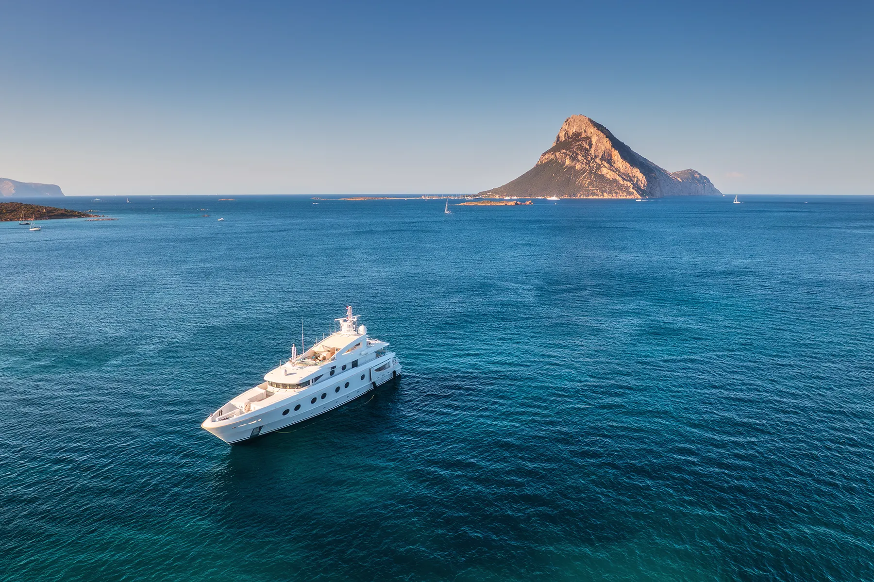 Aerial view of luxury yacht on blue sea at sunny day in summer