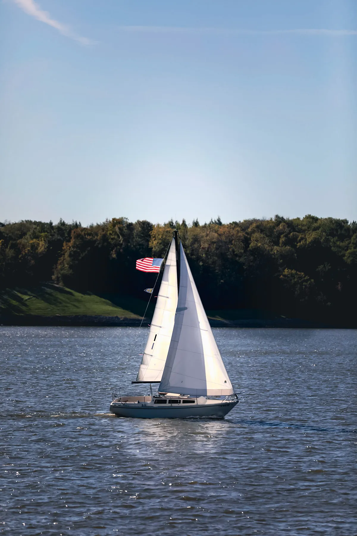 Sailing boat with American flag on the sea Sailing boat with American flag on the sea