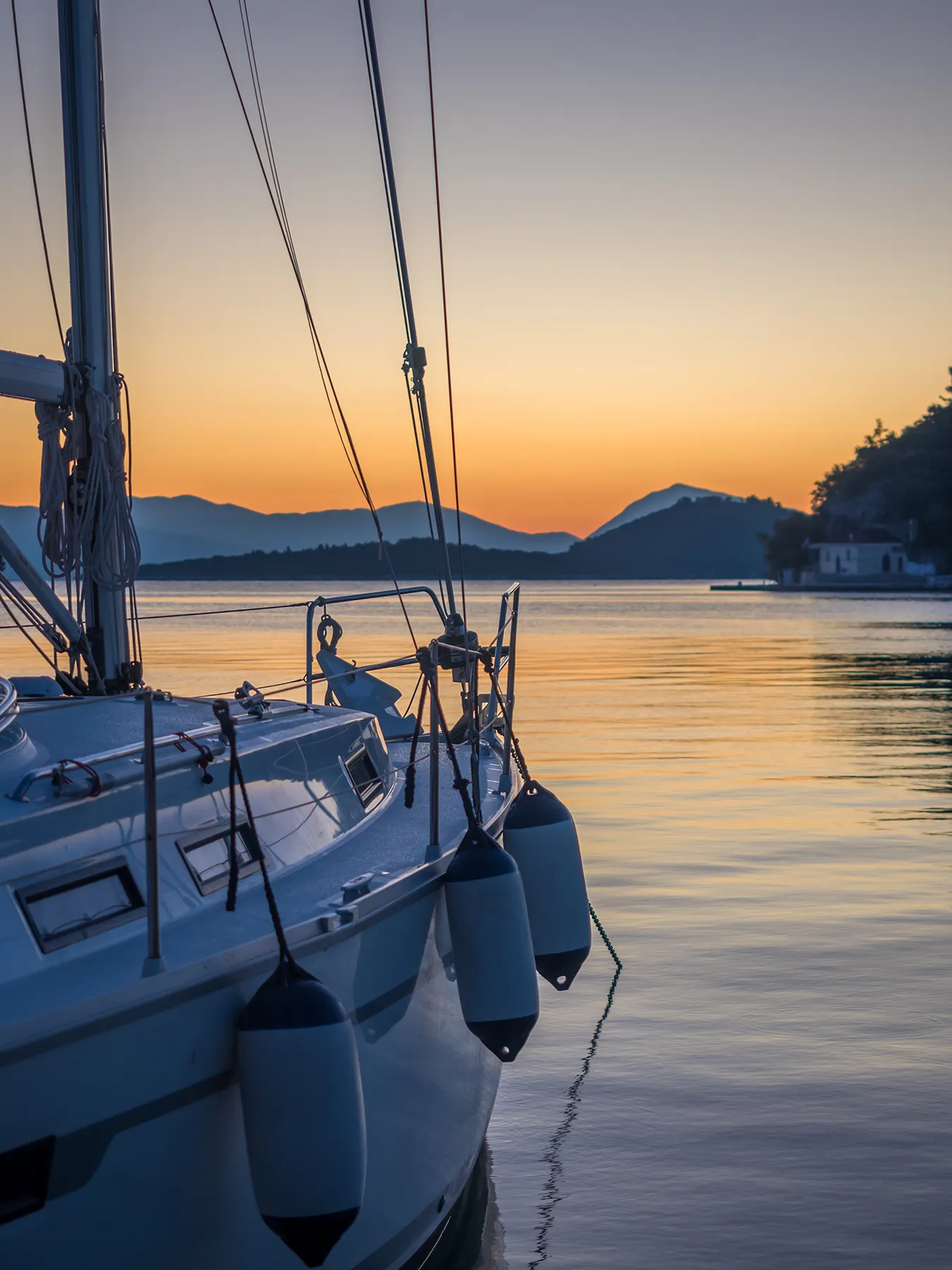 Sailing yacht boat on on ocean at sunrise