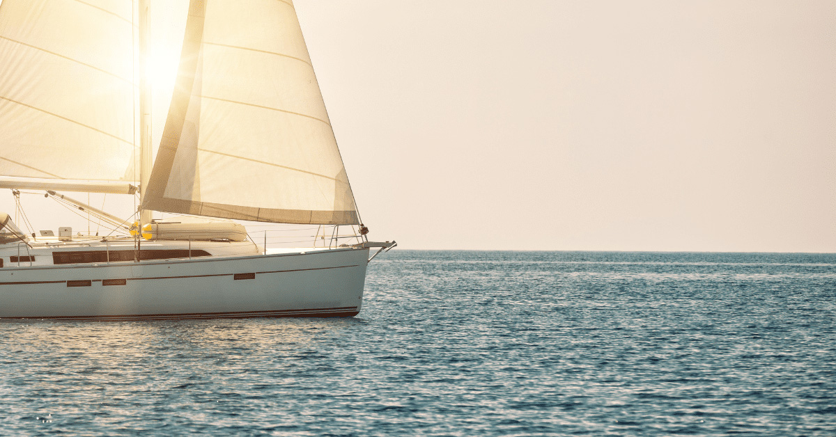 Photo of a sailboat with the sun behind it