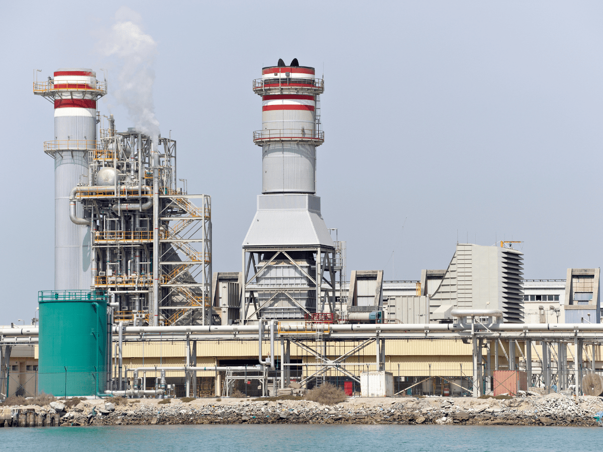 photo of a desalination plant in front of the water