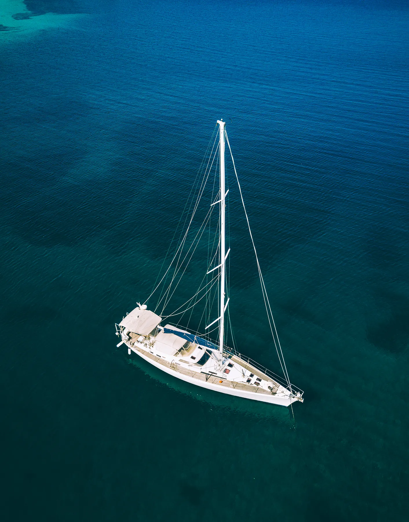 Aerial view of luxury yacht sailboat cruising in blue waters of Greece Aerial view of luxury yacht sailboat cruising in blue waters of Greece