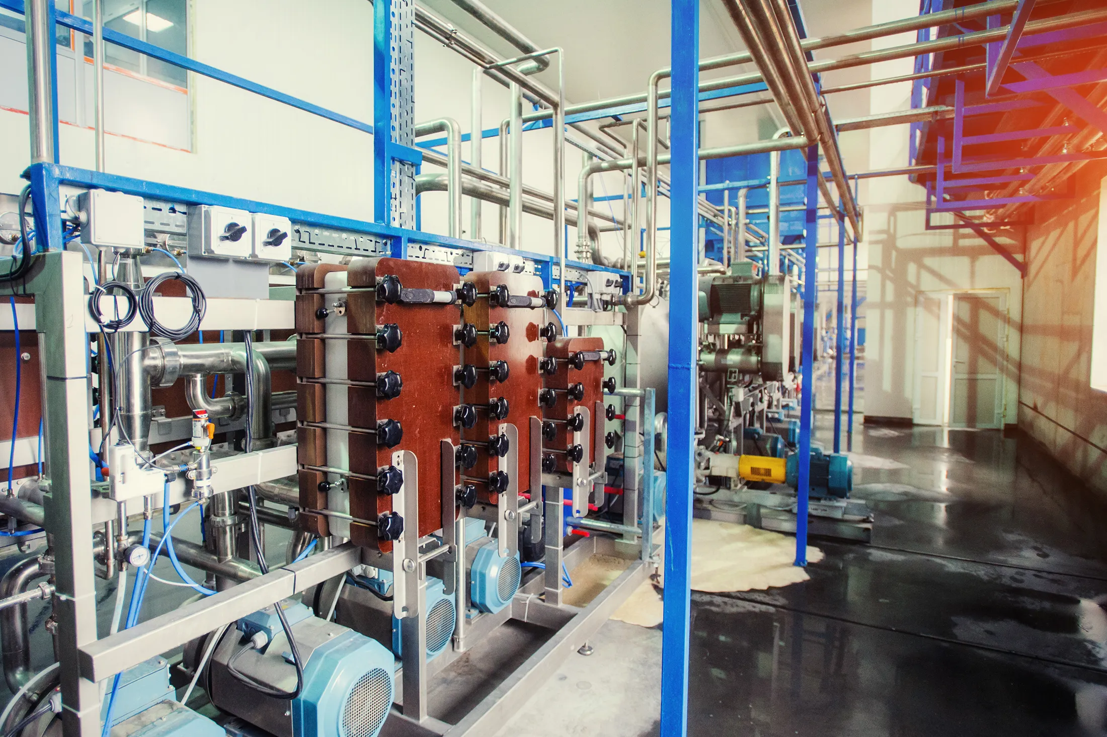 Industrial desalination equipment with pumps, pipes, and filtration units inside a modern water treatment facility.
